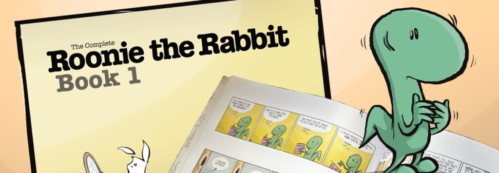 The cover of The Complete Roonie the Rabbit, Book 1, beside the open book, with Hot Chocolate the lizard